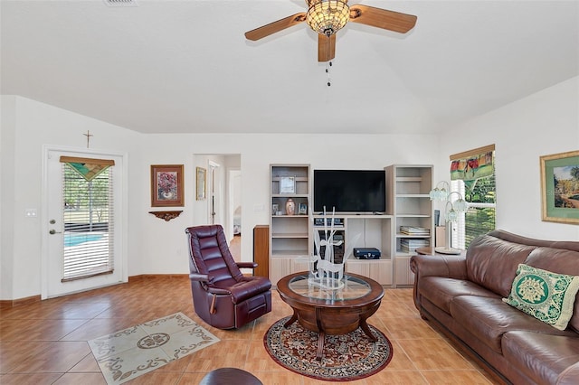 tiled living room featuring ceiling fan