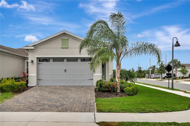 single story home with a garage and a front lawn