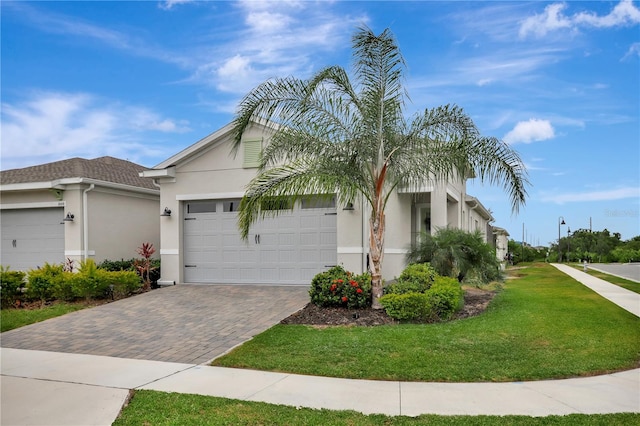 ranch-style house featuring a front yard and a garage