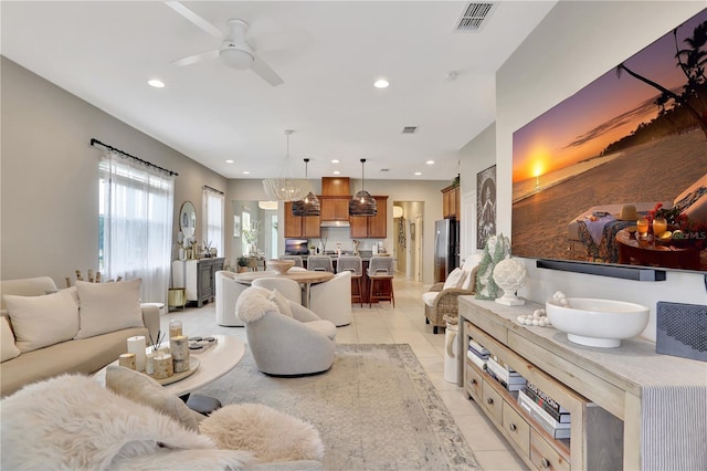 living room with light tile flooring and ceiling fan