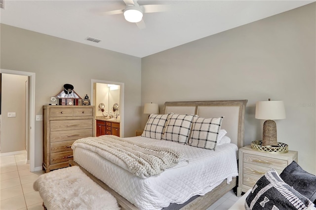 tiled bedroom with ceiling fan and ensuite bathroom