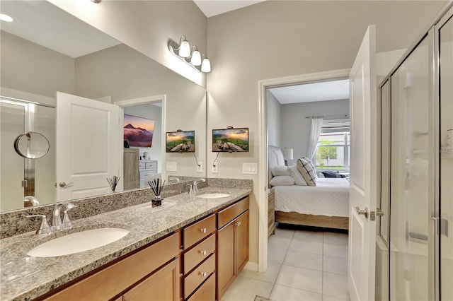 bathroom featuring tile floors, a shower with door, and double sink vanity