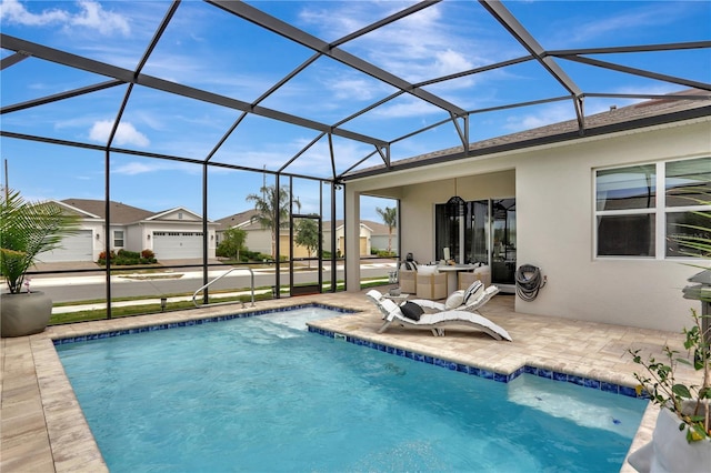 view of swimming pool with a patio area and a lanai