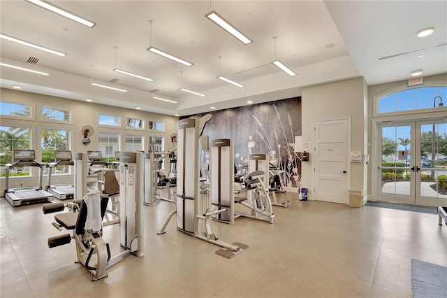 workout area with french doors and light tile floors