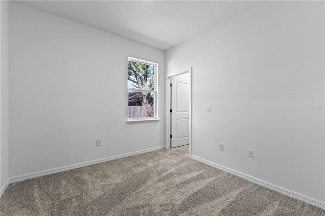 spare room featuring light colored carpet