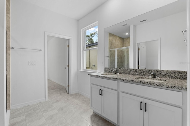 bathroom with walk in shower and vanity