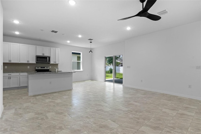 kitchen featuring decorative light fixtures, ceiling fan, light stone counters, white range with electric cooktop, and white cabinets