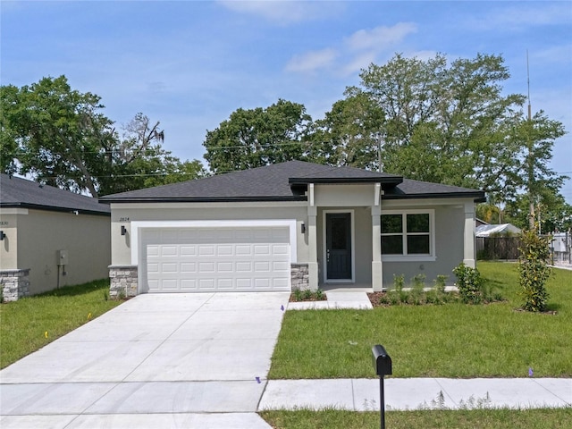 prairie-style home with a garage and a front yard