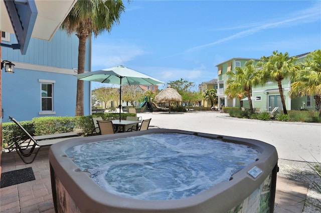 view of swimming pool featuring a hot tub