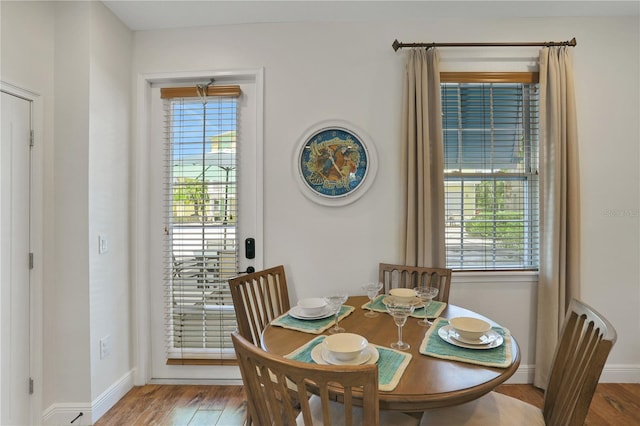 dining area featuring a healthy amount of sunlight and hardwood / wood-style flooring