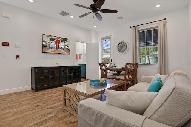 living room featuring ceiling fan and light wood-type flooring