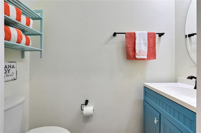 bathroom featuring toilet and vanity