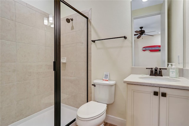 bathroom with a shower with door, ceiling fan, toilet, and vanity