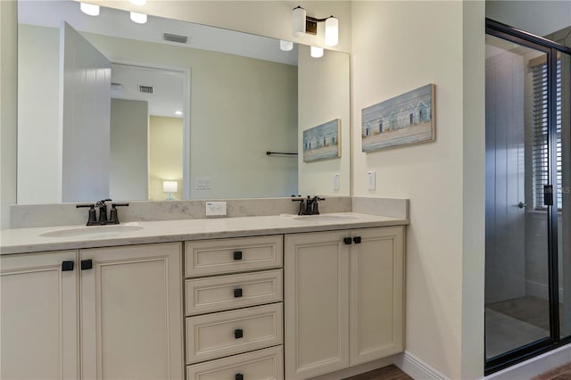 bathroom with walk in shower and double vanity