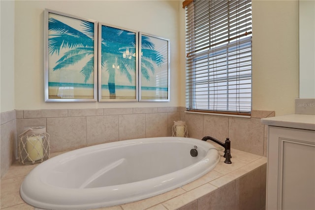 bathroom with tiled bath and vanity