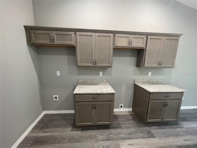 kitchen featuring light stone counters and dark hardwood / wood-style floors