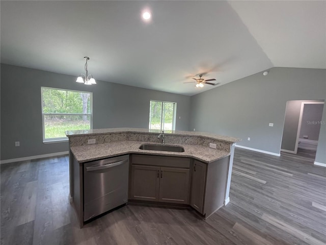 kitchen featuring pendant lighting, a center island with sink, sink, vaulted ceiling, and stainless steel dishwasher