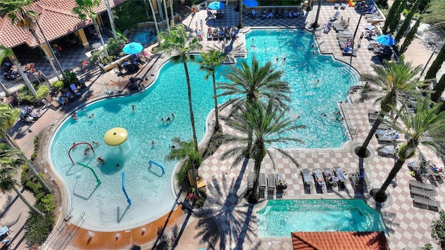 view of pool featuring a patio and a jacuzzi