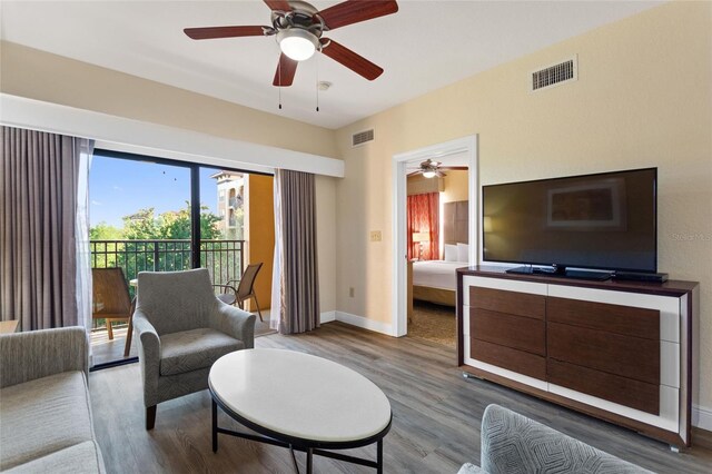 living room with ceiling fan and hardwood / wood-style flooring