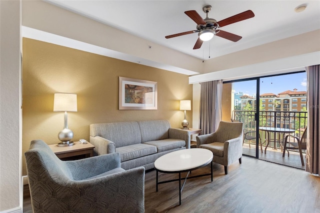 living room with ceiling fan and light wood-type flooring