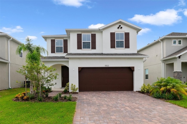 view of front of house with a garage and a front yard