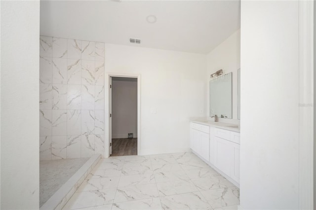 bathroom with walk in shower and vanity