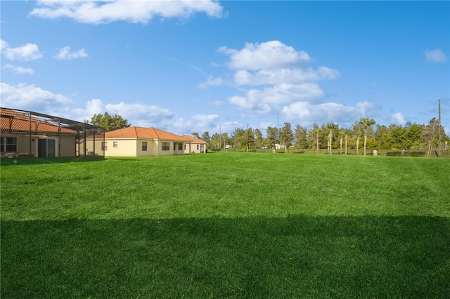 view of yard with glass enclosure