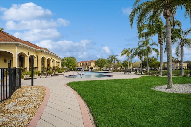 view of home's community featuring a yard, a patio, and a swimming pool