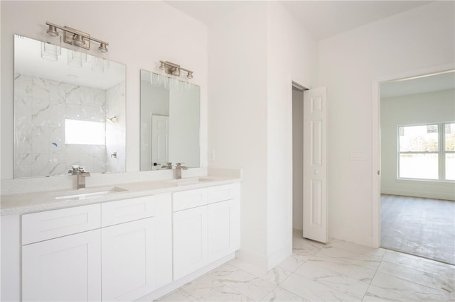 bathroom featuring a tile shower and vanity