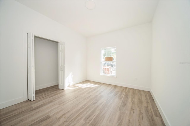 unfurnished bedroom featuring a closet and light hardwood / wood-style flooring