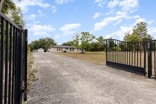 view of gate featuring a lawn