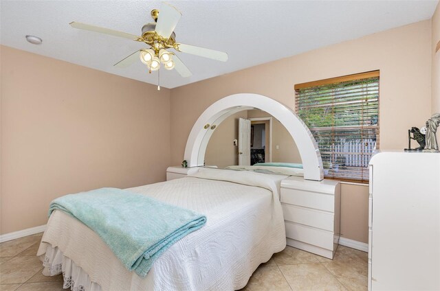 bedroom featuring ceiling fan and light tile floors