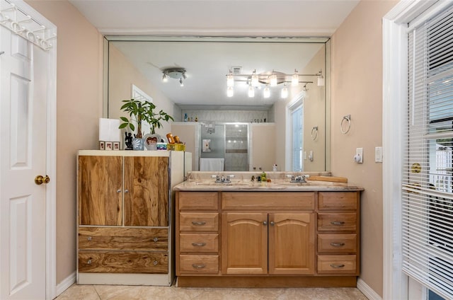 bathroom with tile floors, dual sinks, and large vanity