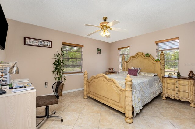 tiled bedroom featuring a textured ceiling and ceiling fan