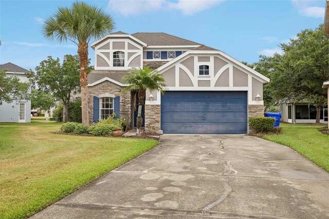 tudor-style house with a front yard and a garage