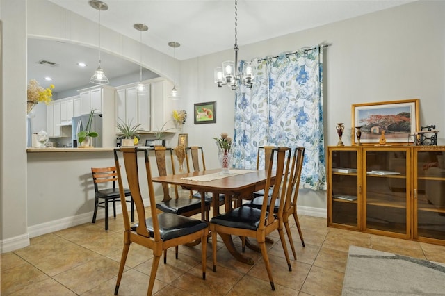 dining space with a chandelier and light tile flooring