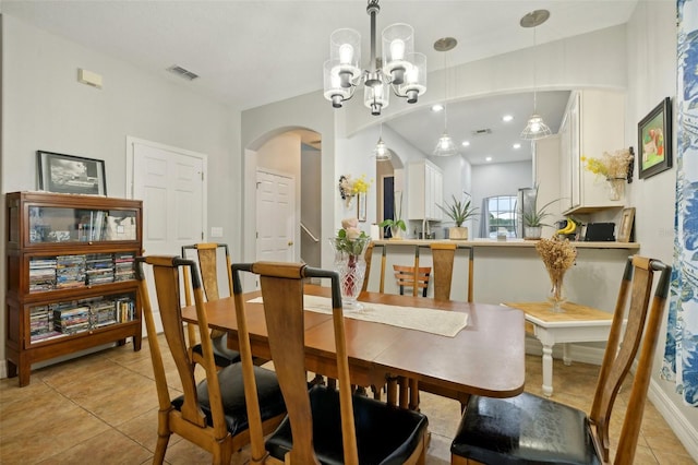 dining room featuring an inviting chandelier and light tile floors