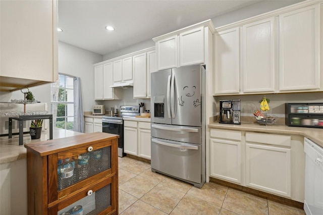 kitchen with white cabinets, light tile flooring, and appliances with stainless steel finishes