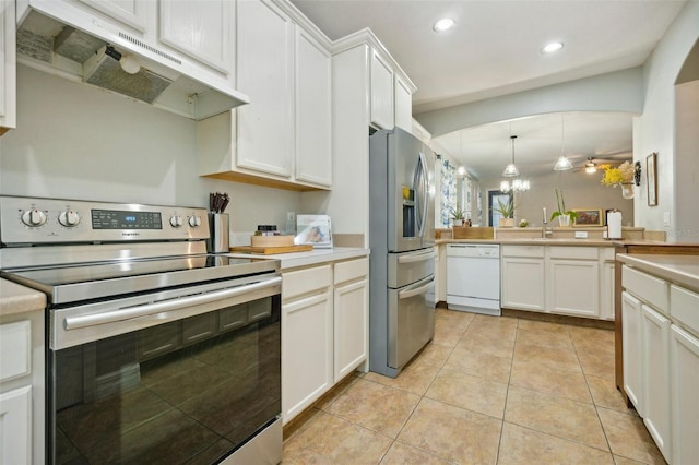 kitchen featuring decorative light fixtures, white cabinets, sink, light tile floors, and appliances with stainless steel finishes