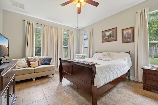 tiled bedroom with ceiling fan