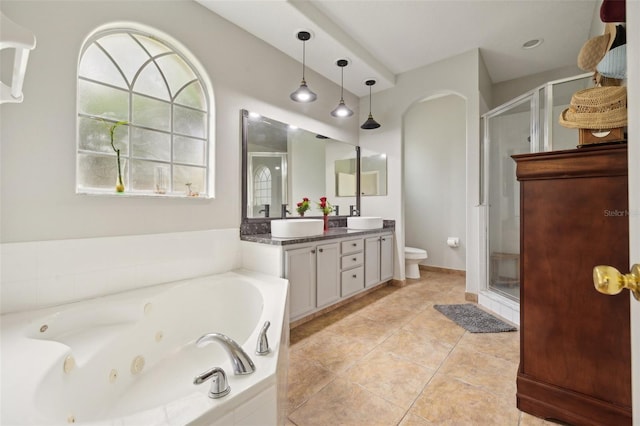 full bathroom featuring tile floors, separate shower and tub, toilet, and vanity with extensive cabinet space