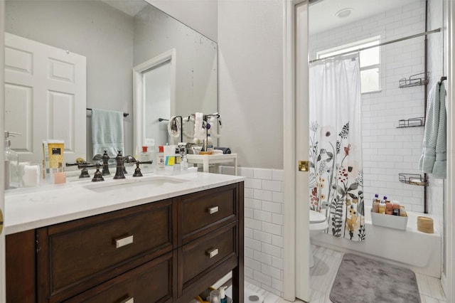 bathroom featuring tile flooring, tile walls, toilet, and vanity