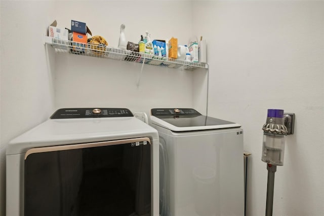 clothes washing area with washing machine and dryer