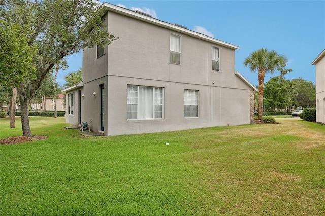 back of house featuring a yard