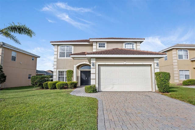 view of front of home featuring a garage and a front lawn