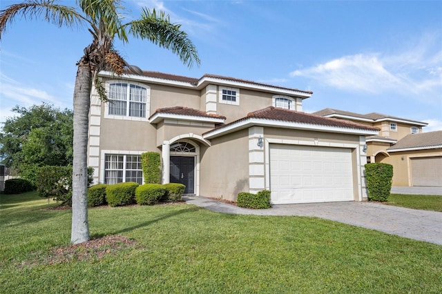 mediterranean / spanish-style house featuring a garage and a front yard