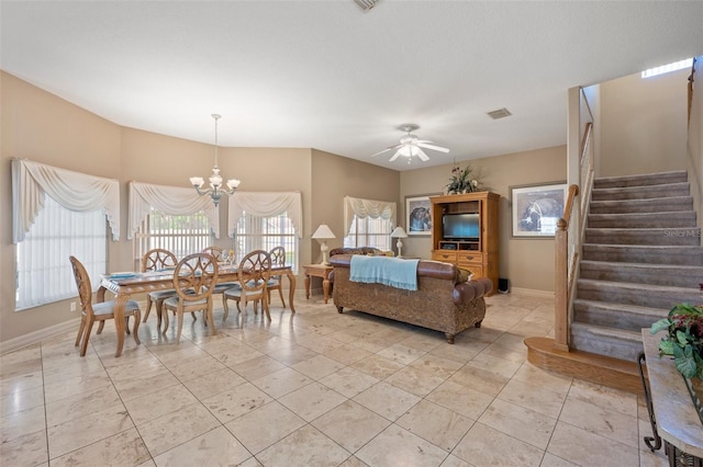 dining area featuring ceiling fan with notable chandelier and light tile patterned floors