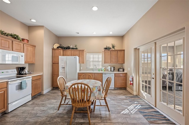 kitchen featuring sink, white appliances, and a wealth of natural light