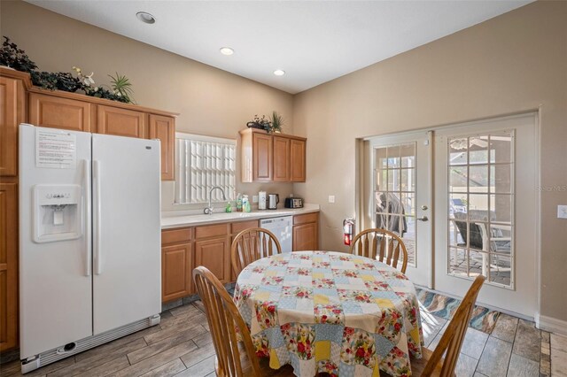 kitchen featuring sink, white appliances, and light hardwood / wood-style floors