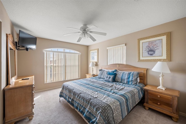 bedroom with carpet floors, a textured ceiling, and ceiling fan